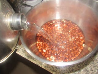 Pouring hot water to groundnuts